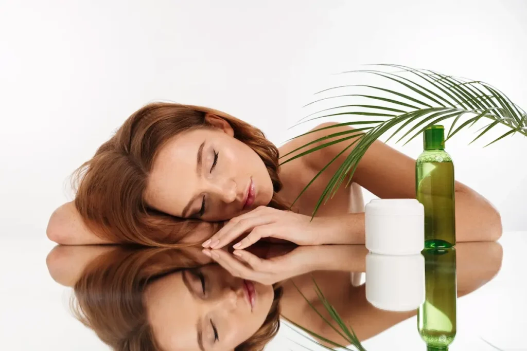 Calm red-haired woman relaxing with natural hair care products — representing the soothing scalp treatments at Dettycated Head Spa Northridge.